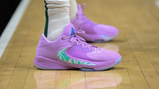 View of purple and green Nike shoes.